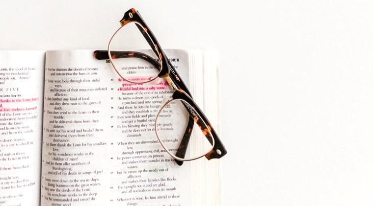 A picture of a bible with a reading glasses placed at the top Teaching Series